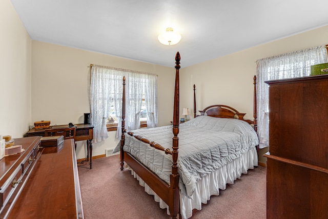 carpeted bedroom featuring multiple windows