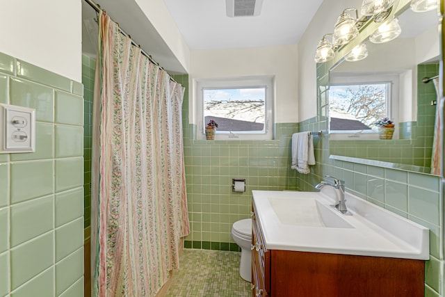 bathroom featuring vanity, tile patterned floors, a shower with curtain, toilet, and tile walls