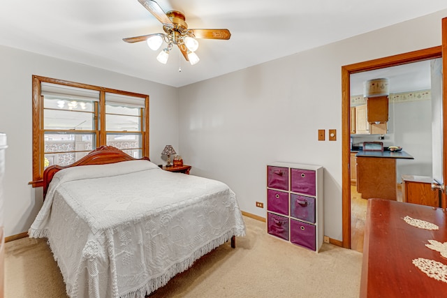 bedroom featuring ceiling fan and light carpet