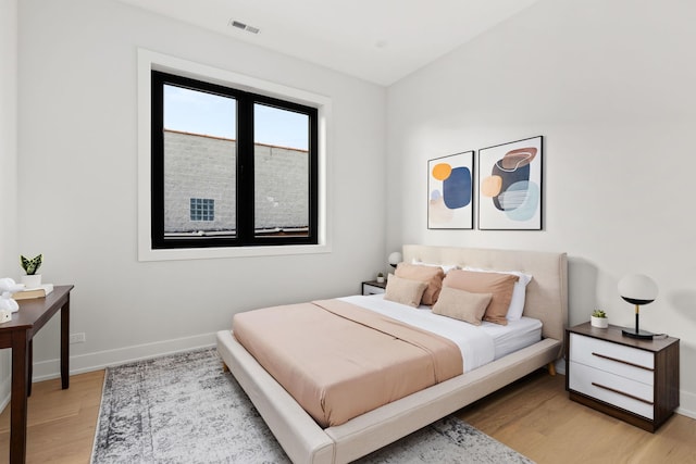 bedroom with hardwood / wood-style flooring