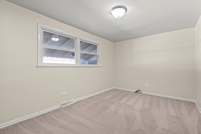 spare room with light carpet