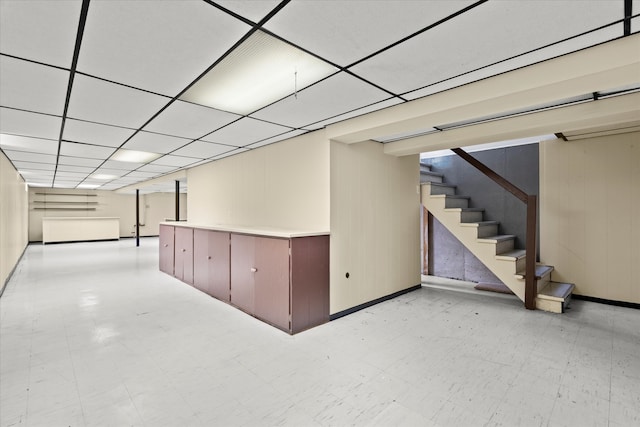 basement with a paneled ceiling