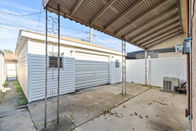 view of patio featuring an outbuilding and central AC