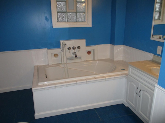 313 E Jackson St, Seneca, IL 61360 - full bathroom with a garden tub, vanity, and tile patterned flooring