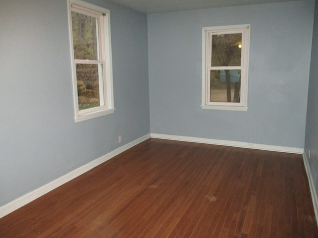 spare room featuring dark wood-type flooring