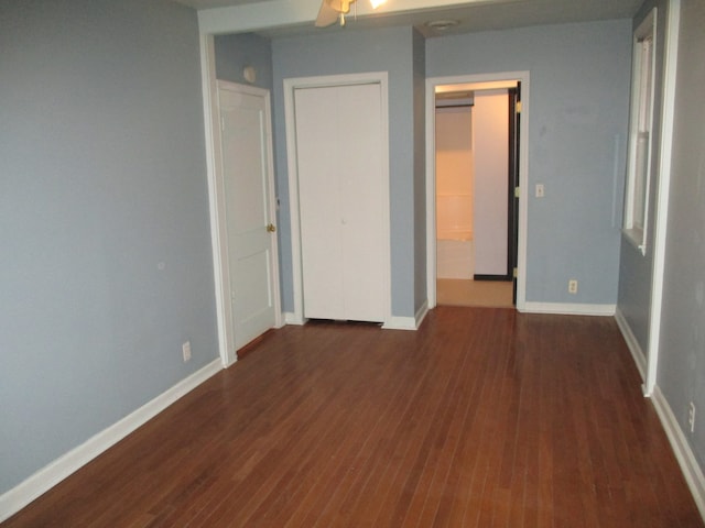 unfurnished bedroom with dark hardwood / wood-style floors