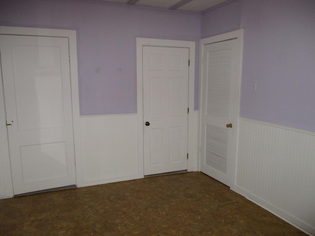 313 E Jackson St, Seneca, IL 61360 - unfurnished bedroom featuring a wainscoted wall