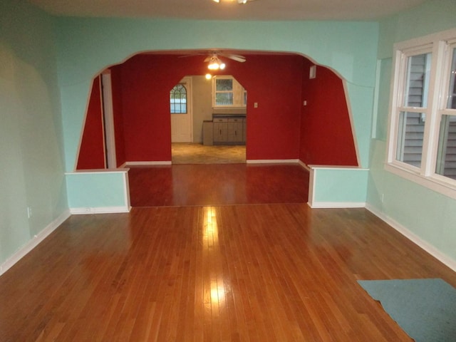 313 E Jackson St, Seneca, IL 61360 - additional living space featuring arched walkways, ceiling fan, wood finished floors, and baseboards