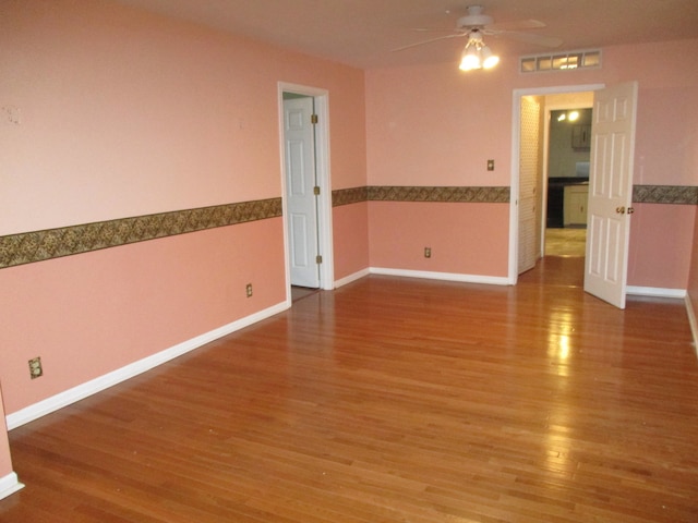 spare room featuring hardwood / wood-style flooring and ceiling fan