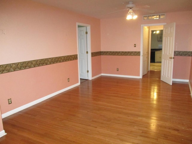 313 E Jackson St, Seneca, IL 61360 - spare room with ceiling fan, wood finished floors, and baseboards