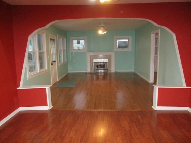 313 E Jackson St, Seneca, IL 61360 - unfurnished living room featuring baseboards, wood finished floors, and a ceiling fan