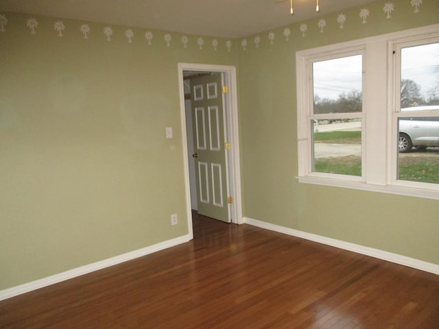 313 E Jackson St, Seneca, IL 61360 - unfurnished room with dark wood-style flooring and baseboards