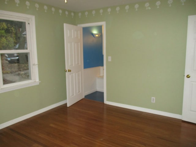 empty room featuring dark hardwood / wood-style flooring