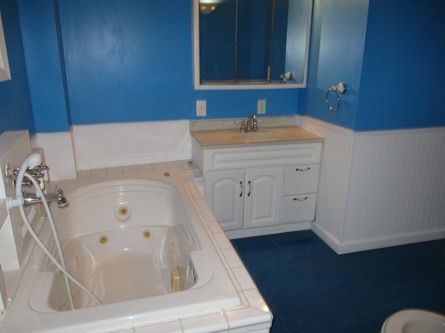 313 E Jackson St, Seneca, IL 61360 - full bathroom with a jetted tub, a wainscoted wall, and vanity