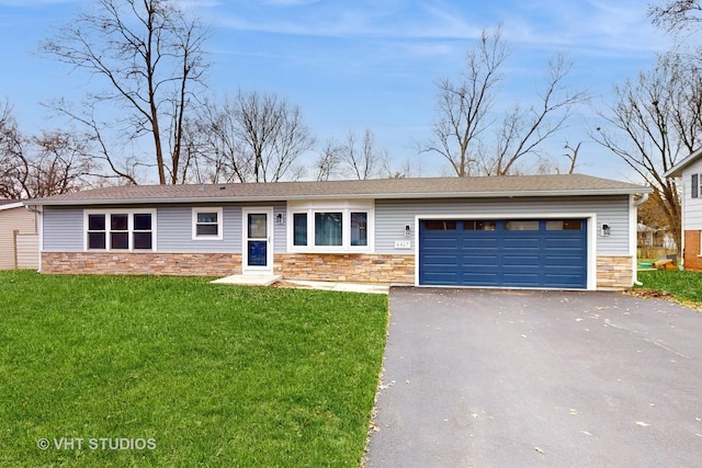 ranch-style home with a garage and a front lawn