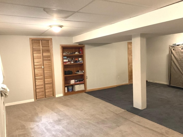 basement with carpet and a drop ceiling