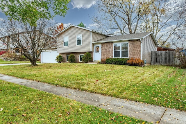 tri-level home with a garage and a front lawn