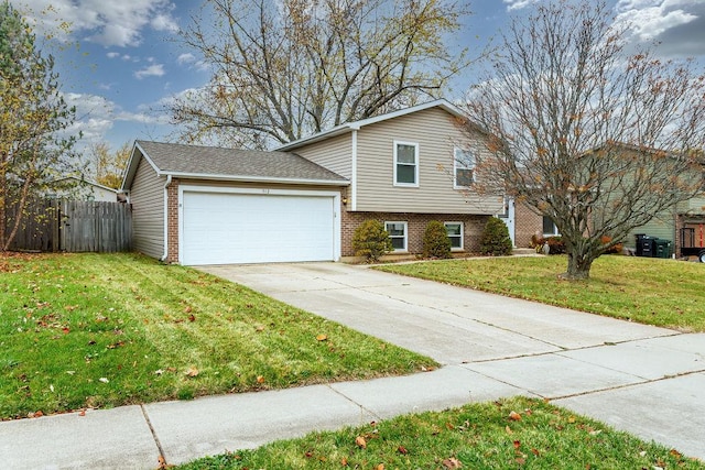 tri-level home featuring a front lawn and a garage