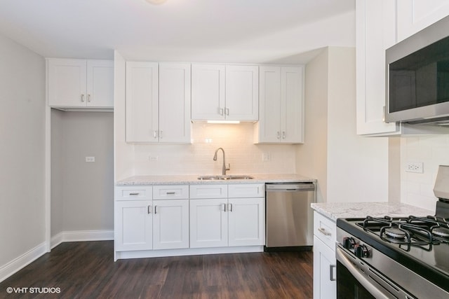 kitchen featuring white cabinetry, sink, appliances with stainless steel finishes, and dark wood-type flooring