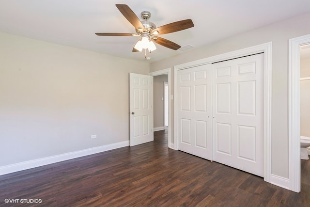 unfurnished bedroom featuring ceiling fan, a closet, and dark wood-type flooring