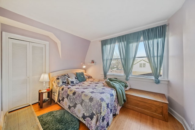 bedroom with light hardwood / wood-style flooring and a closet