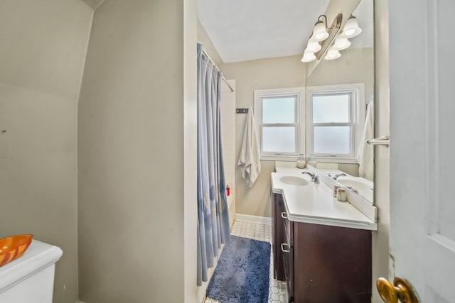 bathroom with a shower with shower curtain, vanity, and toilet