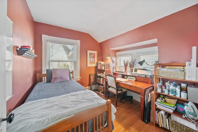 bedroom featuring vaulted ceiling and light hardwood / wood-style flooring