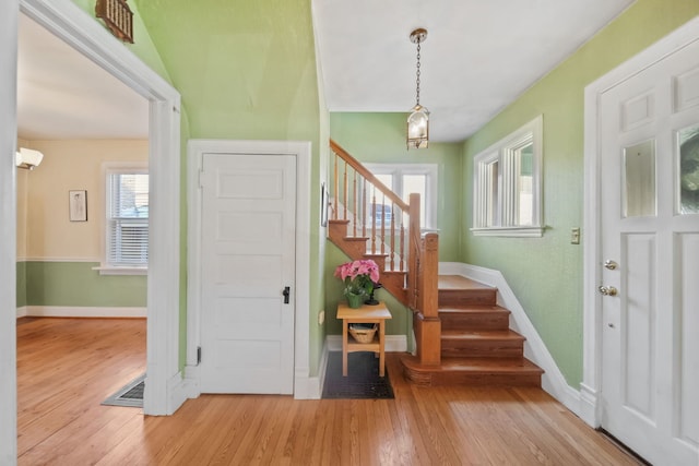 foyer with a wall mounted AC and hardwood / wood-style floors