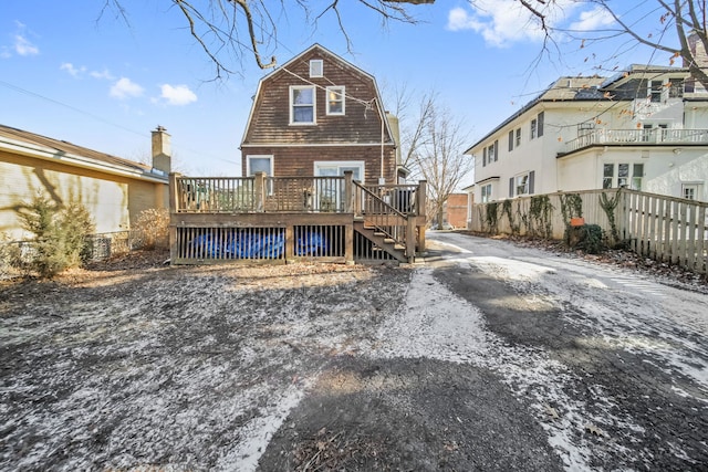 rear view of property featuring a deck