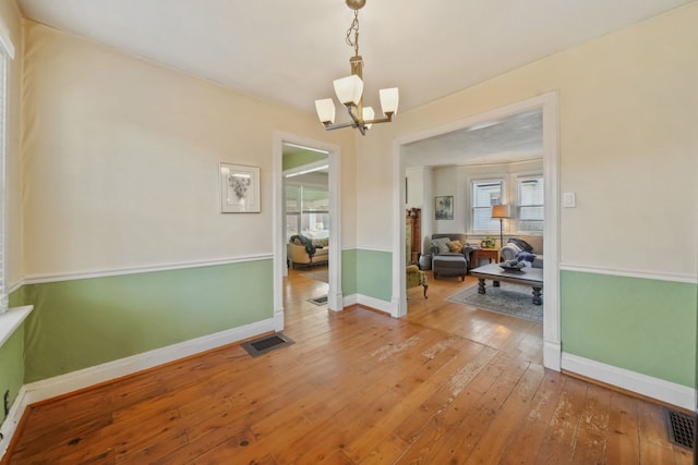 dining area with a notable chandelier and hardwood / wood-style flooring