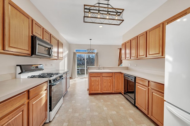 kitchen featuring kitchen peninsula, sink, hanging light fixtures, and black appliances