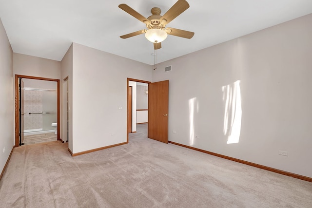 unfurnished bedroom with ensuite bath, ceiling fan, and light colored carpet