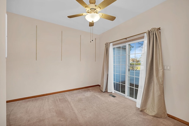 empty room featuring ceiling fan and light colored carpet