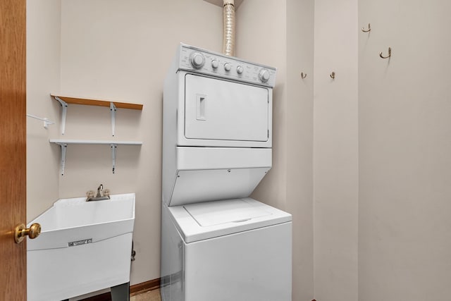 clothes washing area with sink and stacked washer and clothes dryer