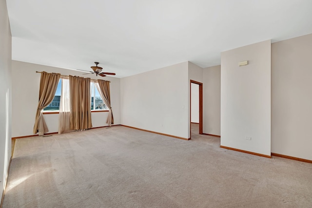 unfurnished room featuring light colored carpet and ceiling fan