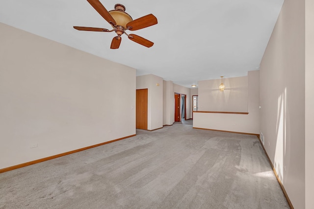 unfurnished living room featuring light colored carpet and ceiling fan