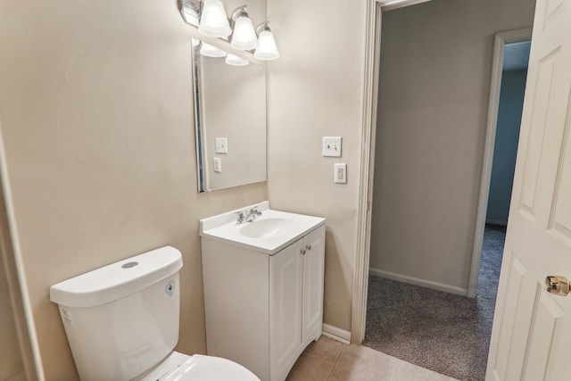 bathroom featuring tile patterned flooring, vanity, and toilet