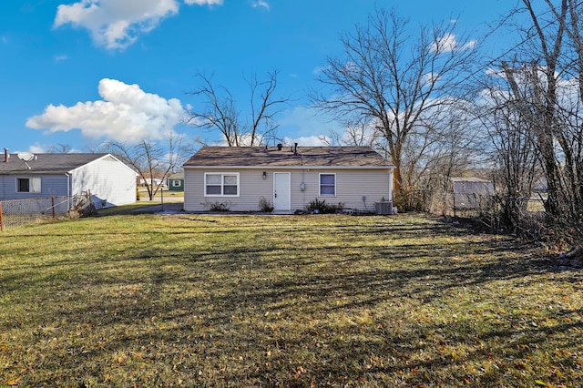 rear view of house with a lawn and central AC