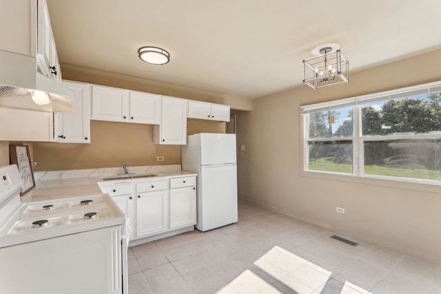 kitchen featuring white appliances, sink, decorative light fixtures, white cabinetry, and light tile patterned flooring