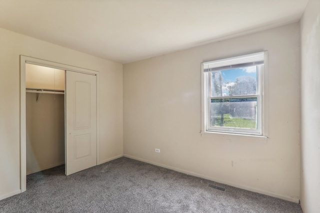 unfurnished bedroom with carpet floors and a closet