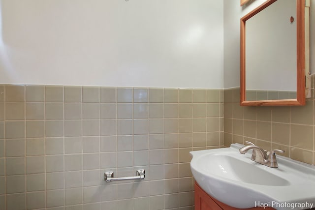 bathroom featuring vanity and tile walls