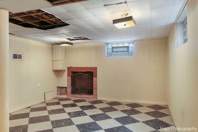 basement featuring a brick fireplace