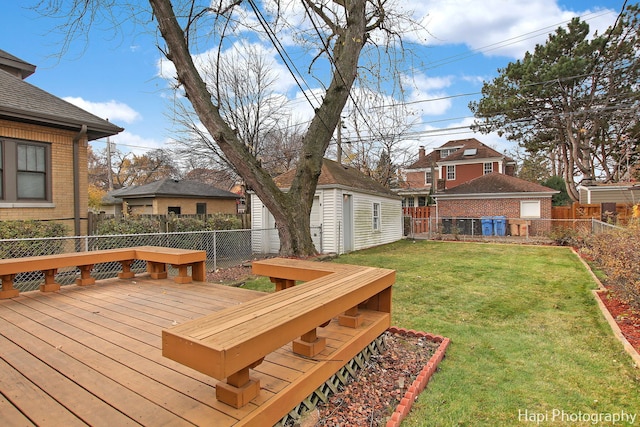 wooden deck featuring a shed and a lawn