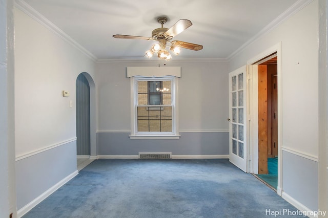 empty room with carpet, ceiling fan, and crown molding