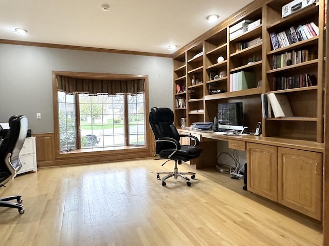 home office with light hardwood / wood-style floors and ornamental molding