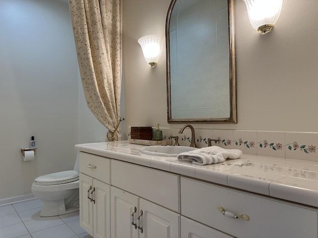 bathroom featuring tile patterned floors, vanity, and toilet