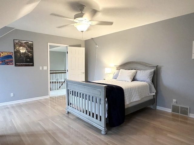 bedroom with hardwood / wood-style flooring and ceiling fan