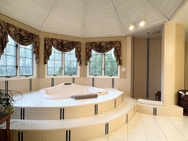 bathroom with vaulted ceiling, plenty of natural light, and wood ceiling