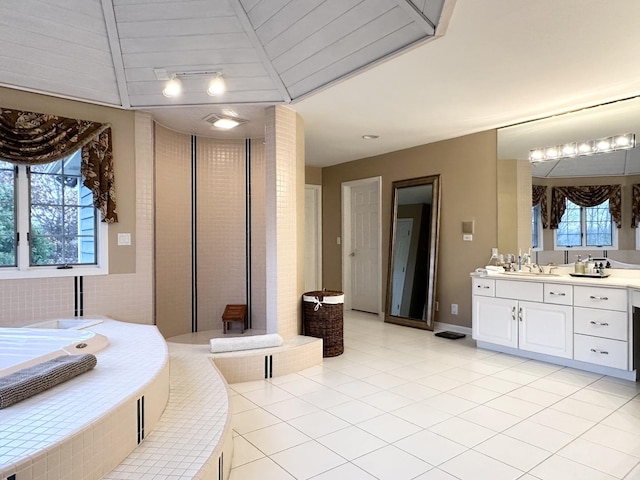 bedroom with vaulted ceiling with beams, sink, multiple windows, and light tile patterned flooring