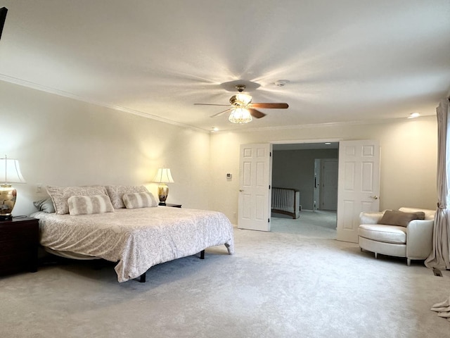 bedroom with ceiling fan, crown molding, and carpet floors